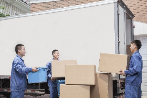 Experienced movers carrying furniture in a Chiswick property