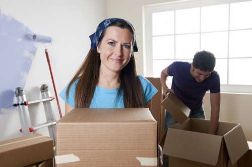 Professional movers carrying furniture from a Chiswick home