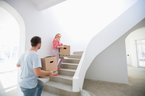 Professional movers handling household items and protective wrapping for a Chiswick relocation